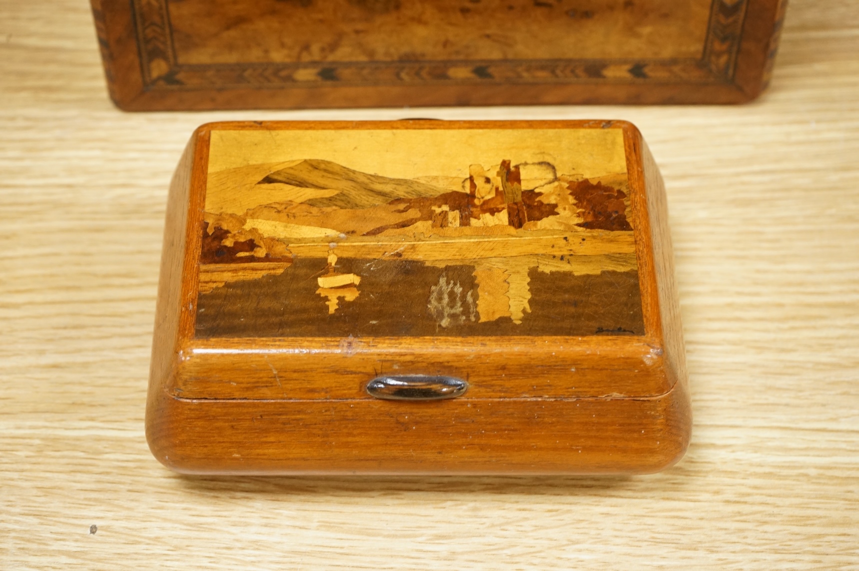 A walnut and German bandwork tea caddy, a brass bound walnut writing slope and an Art Deco Killarney inlaid trinket box, largest 15cm high, 30cm wide.